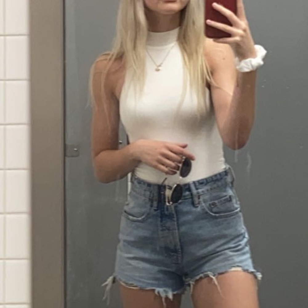 Sleeveless white turtleneck